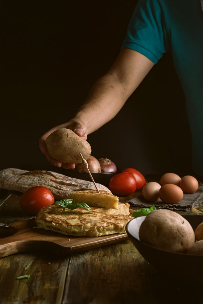 Crop man holding potato near pie