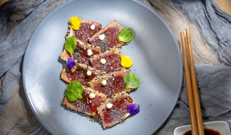 Tasty tuna tataki decorated with green and seeds