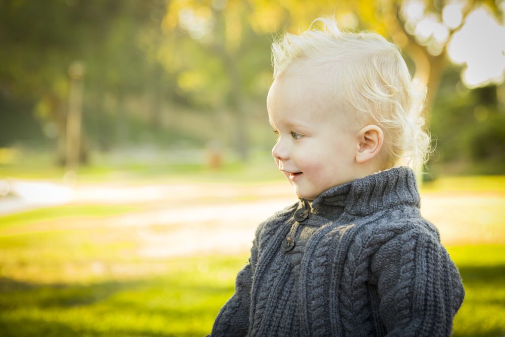 Adorable Blonde Baby Boy Outdoors at the Park.