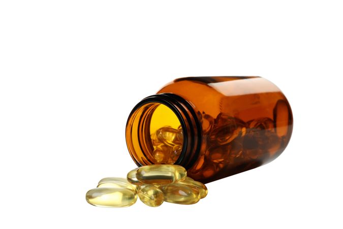 Brown bottle with omega pills, isolated on blank background