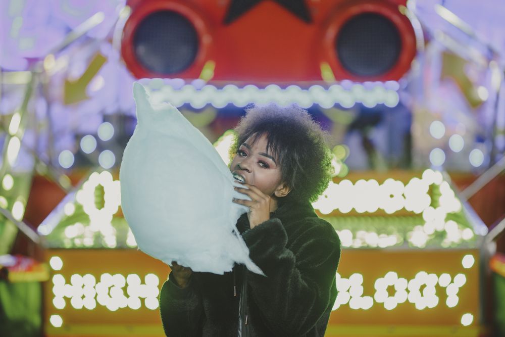 Cheerful Black woman with candy floss