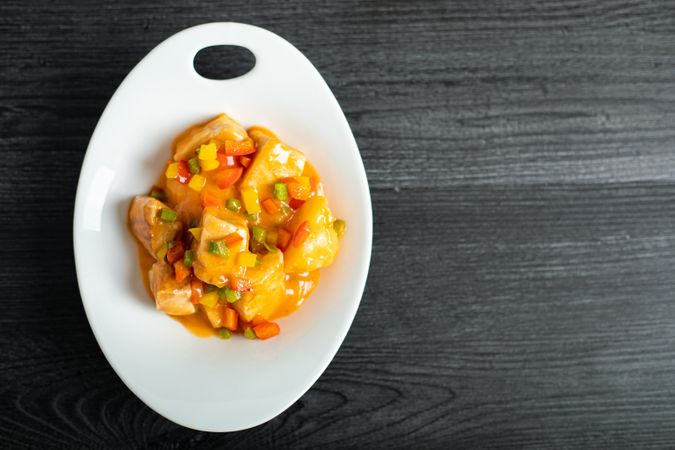 Fresh juicy Marmitako dashi in oval plate
