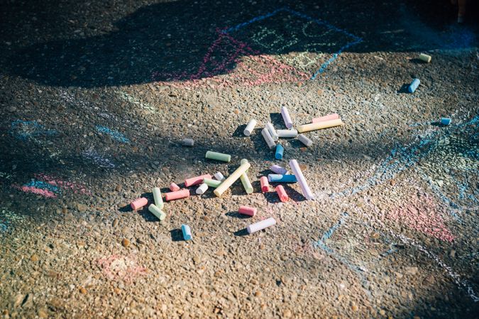 Colored chalk on pavement in sunny day