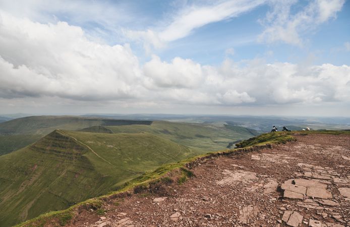 People sitting on the end of a trail on the Brecon Beacons mountain range