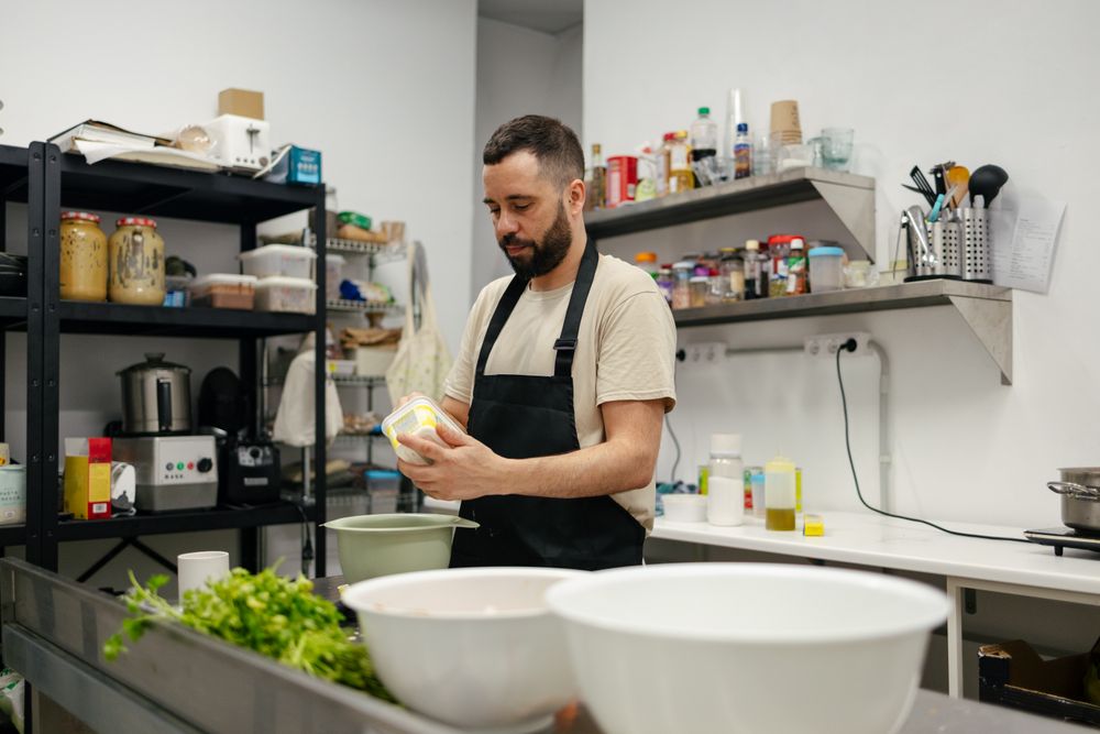 Young chef cooking in professional kitchen