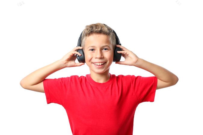 Boy in red t-shirt with headphones isolated on blank background