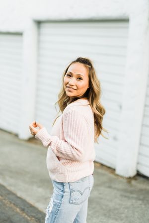 Woman in pink sweater standing outdoor