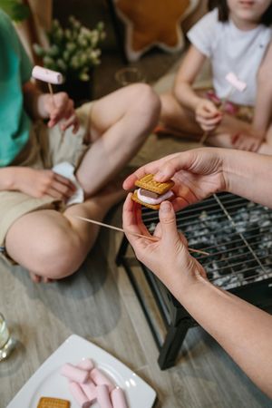 S'more that a family is preparing with a small barbecue at home