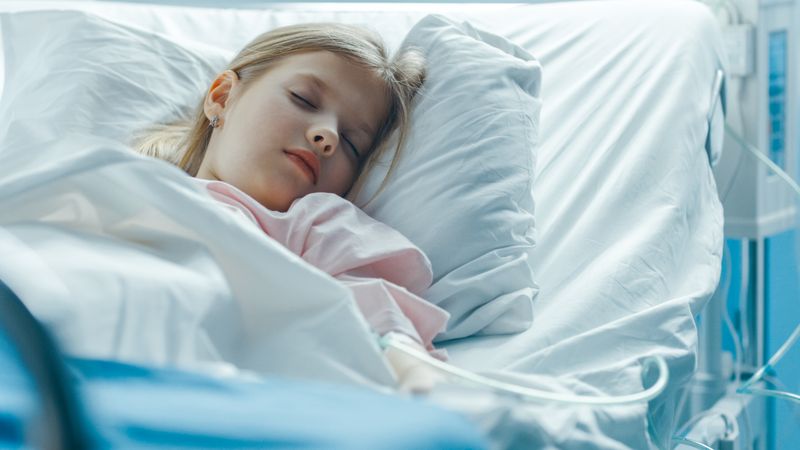 Cute Little Sick Girl Sleeps on a Bed in the Children's Hospital