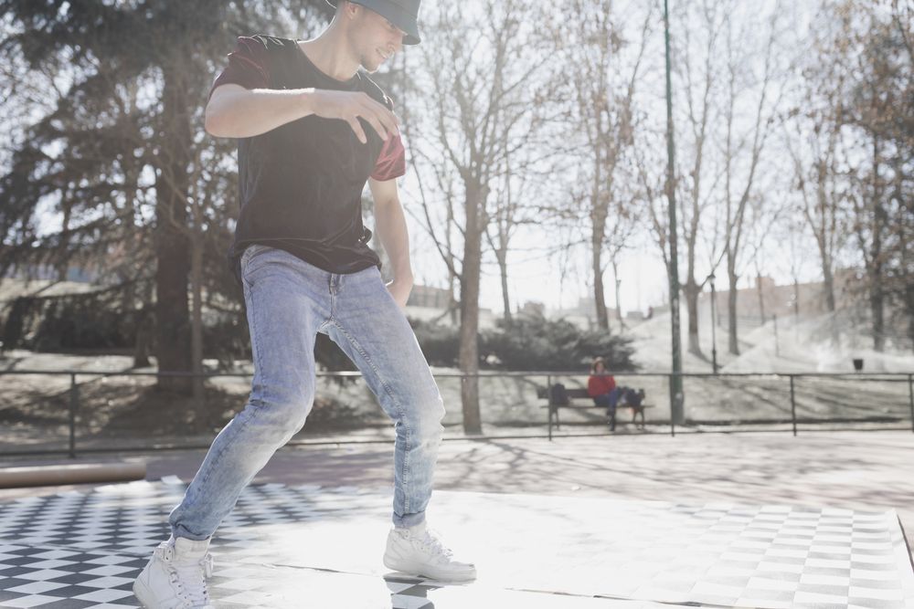 Man dancing break dance in park