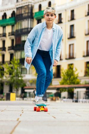 woman skating on a city square. front view
