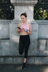 Woman with sportswear listening to music with headphones