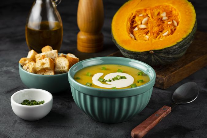 Bowl with pumpkin soup on the table.