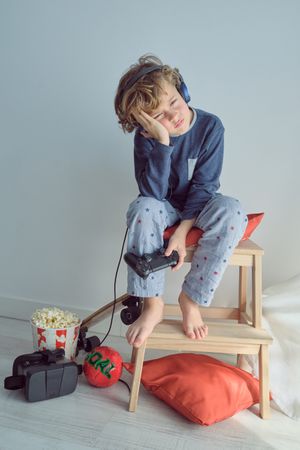 Upset kid in headphones losing video game