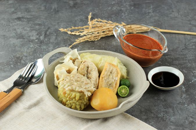 Plate of steamed dumplings, Baso Tahu Indonesian street food served with peanut and soy sauce