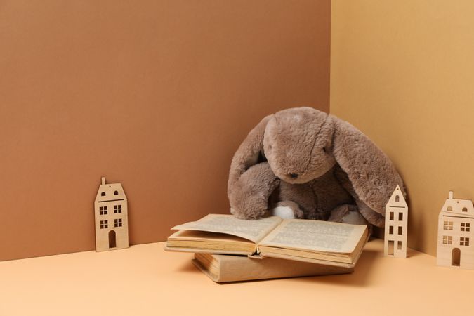 A children's book with toys on a beige background.