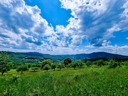 A sunlit tapestry of clouds above a green landscape 