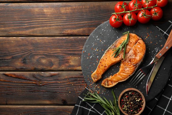 Composition with tasty grilled salmon on wooden background, top view