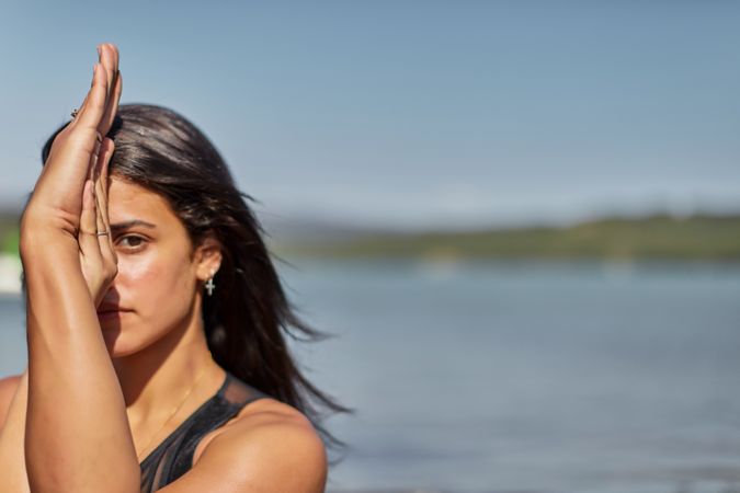 Portrait of young woman holding her hands in yoga pose