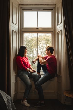 Couple looking at window in old house