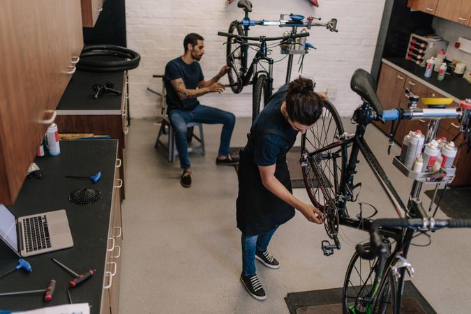 Workers repairing bicycles in a cycle shop