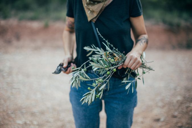 Woman in t-shirt holding olive branches