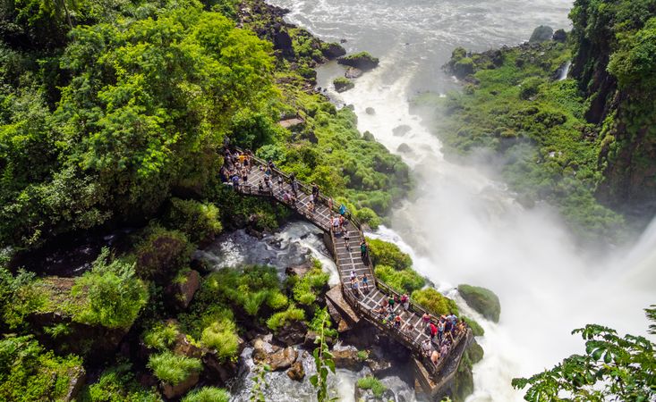 Tourists on terrace near waterfall