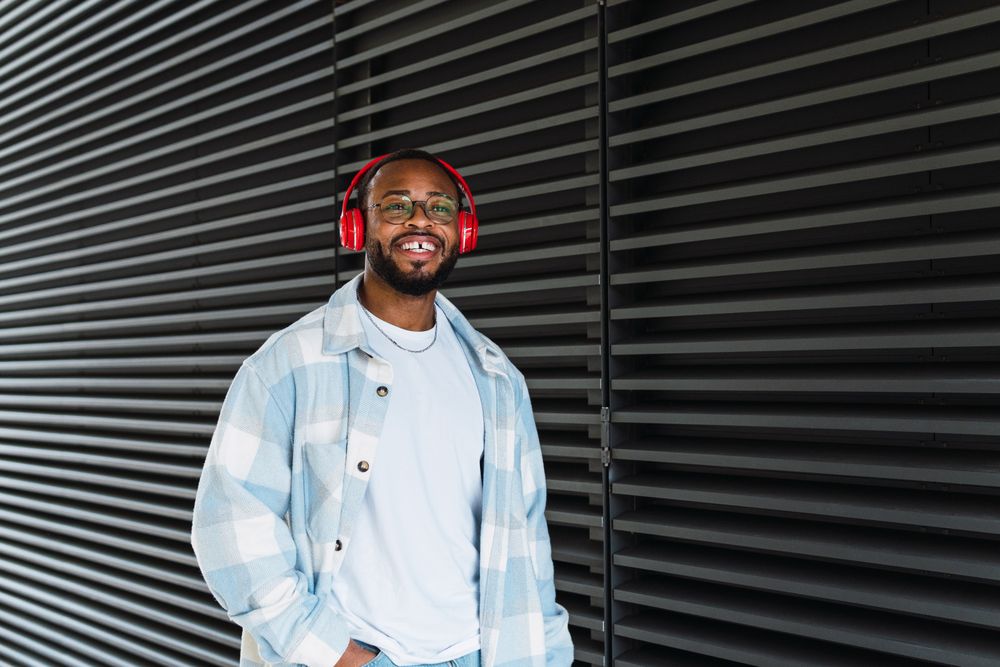 Smiling Black man in headphones and jacket