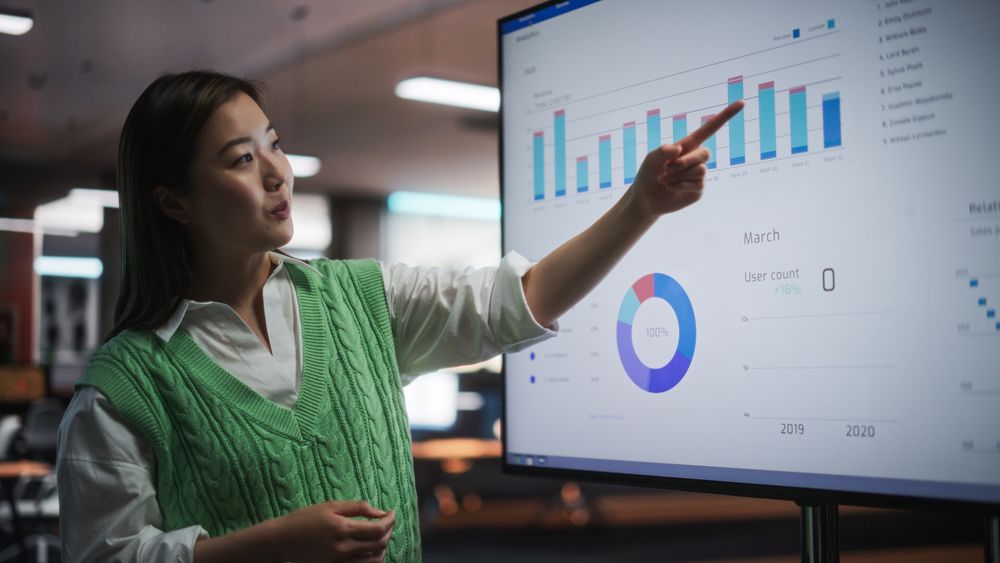 Creative Office Meeting: Portrait of Beautiful Asian Female Project Manager Presenting Financial Goals For Marketing Strategy