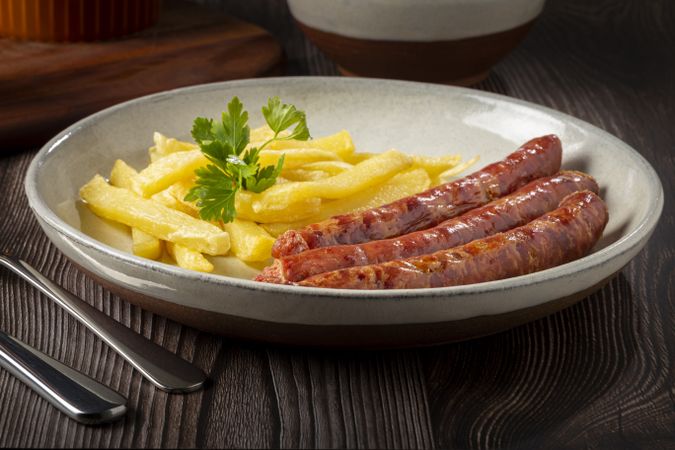 Grilled German sausage with french fries.