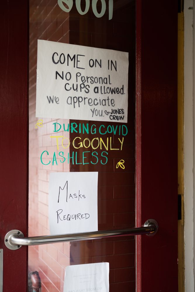 Angled view of handmade signs in coffee shop for Covid safety requirements