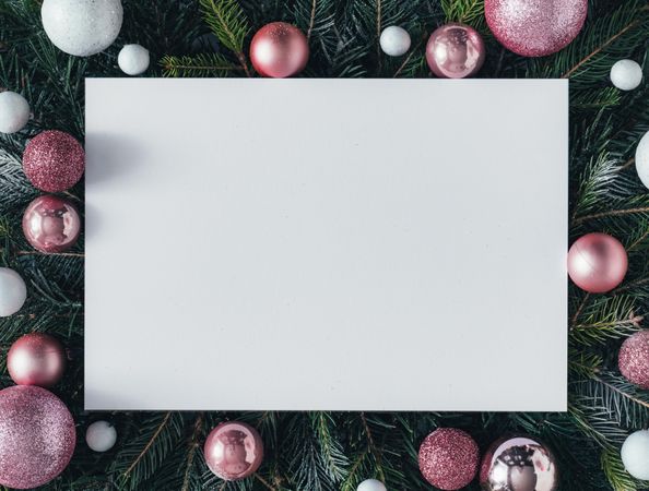 Pine tree branches with pink baubles and paper center