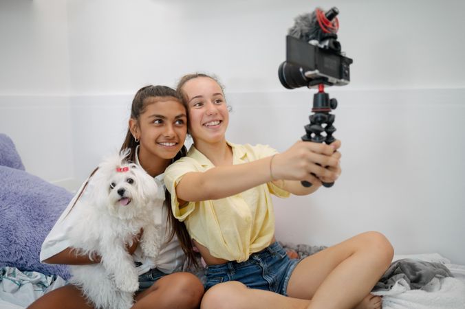 Teenage girlfriends taking selfie on camera