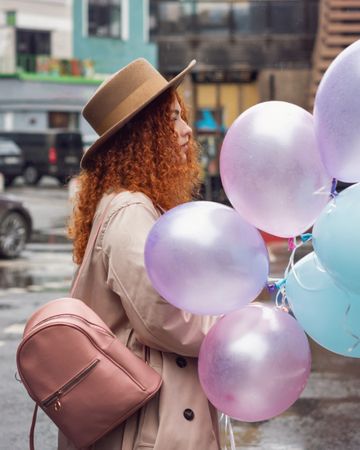 Woman walking outside with balloons