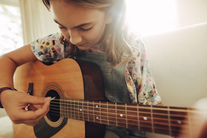 Girl playing music on guitar