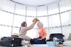 Two Young Asian Friend Preparing Travelling