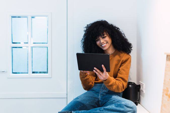 Black woman with tablet on counter