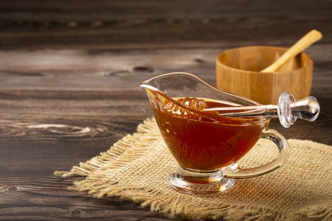Honey in glass bowl on the table.