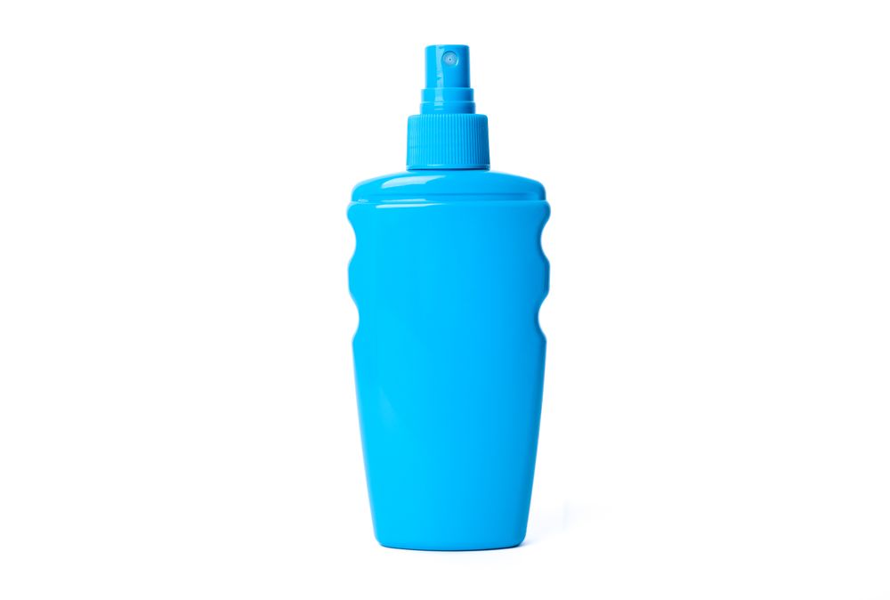 Sunscreen spray isolated on neutral background. Summer vacation accessories