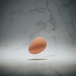 Brown egg on marble background