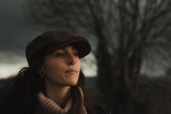 Young woman in warm clothes in forest
