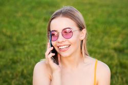 Female in bright sunglasses talking on phone