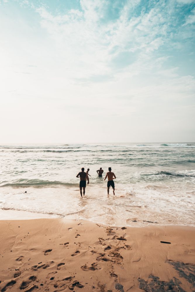 People running toward the sea