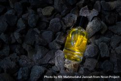 Yellow perfume bottle mock up laying in rocky terrain 5RVKaO