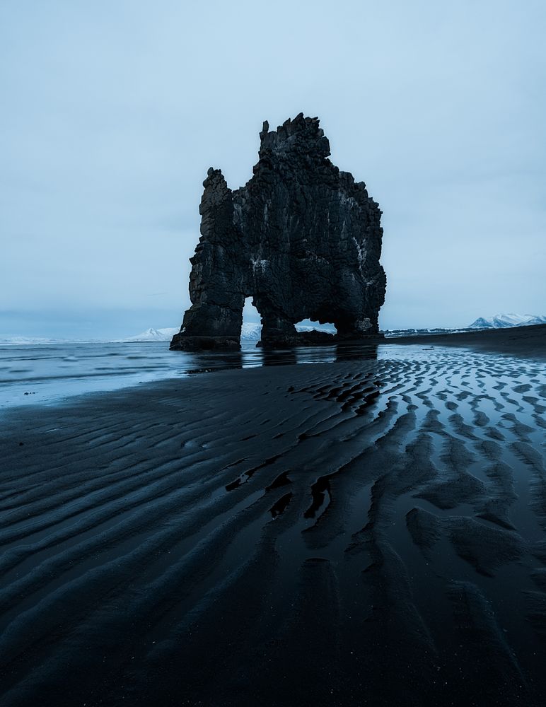 Rocky shoreline of sea in clouds in Iceland