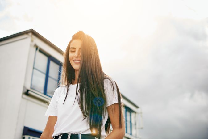 Shot looking up at sky and women with long brown hair and eyes closed