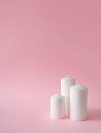 Christmas candles on pink background