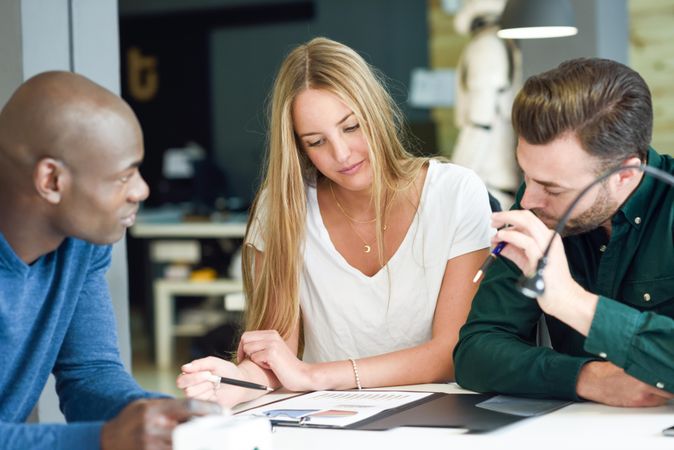 Multi-ethnic colleagues working through graphs at work