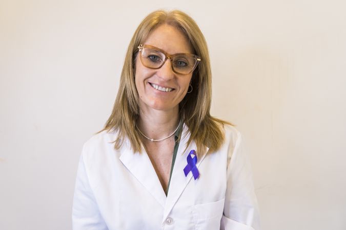 Female doctor using breast cancer awareness ribbon.