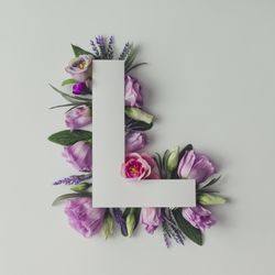 Colorful flowers, leaves and paper “L”